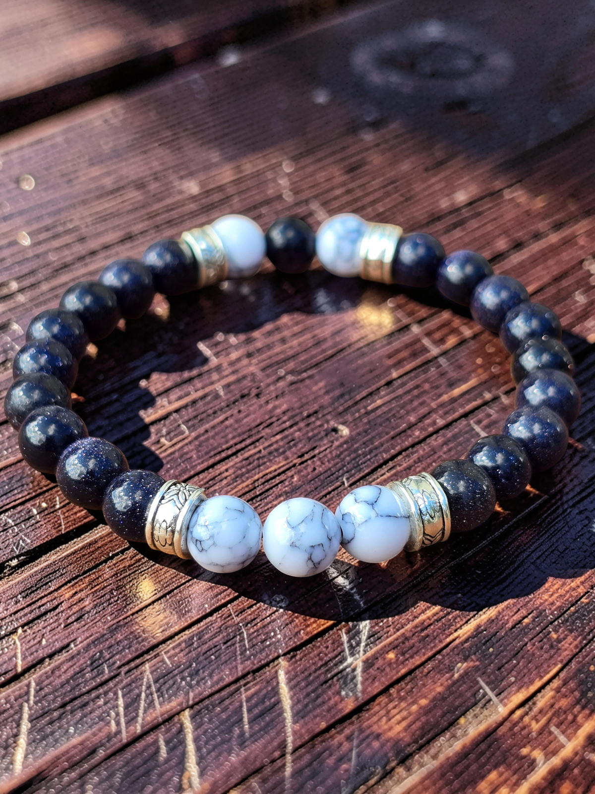 Bracelet with blue and white beads on a wooden surface