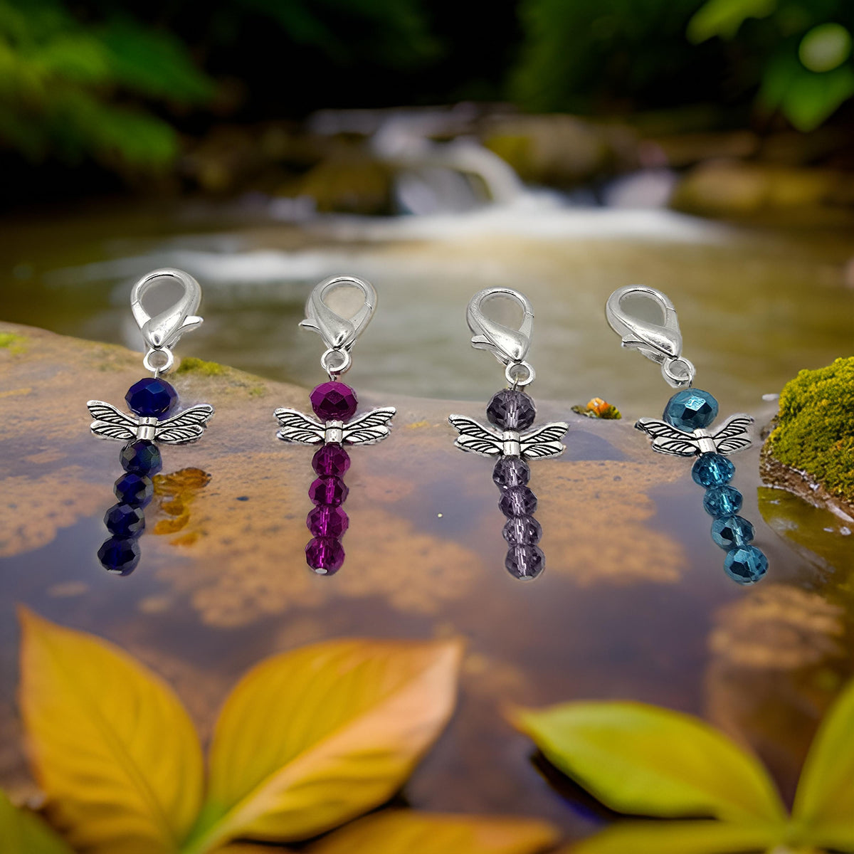 Four beaded dragonfly zipper charms with silver wings and clasps in navy blue, magenta, lavender, and teal.