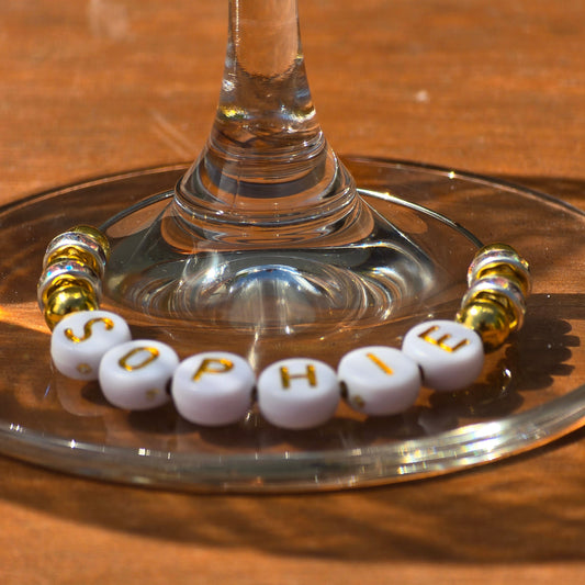 personalised wine glass charm with gold beads and letter beads spelling Sophie