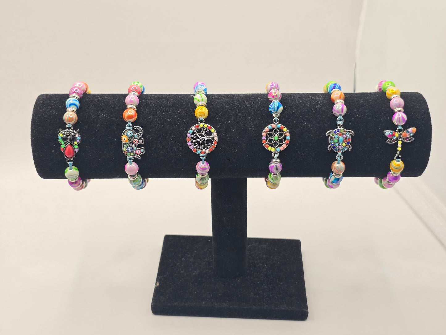 Kids beaded bracelet, multicoloured elastic bracelet with various colourful charms