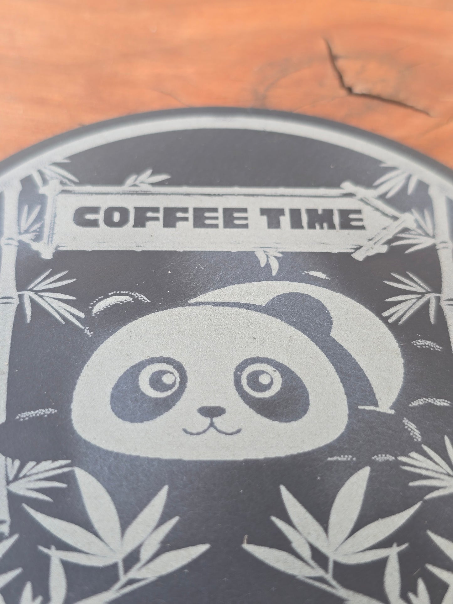 Stylized panda design with 'Coffee Time' text on a wooden background