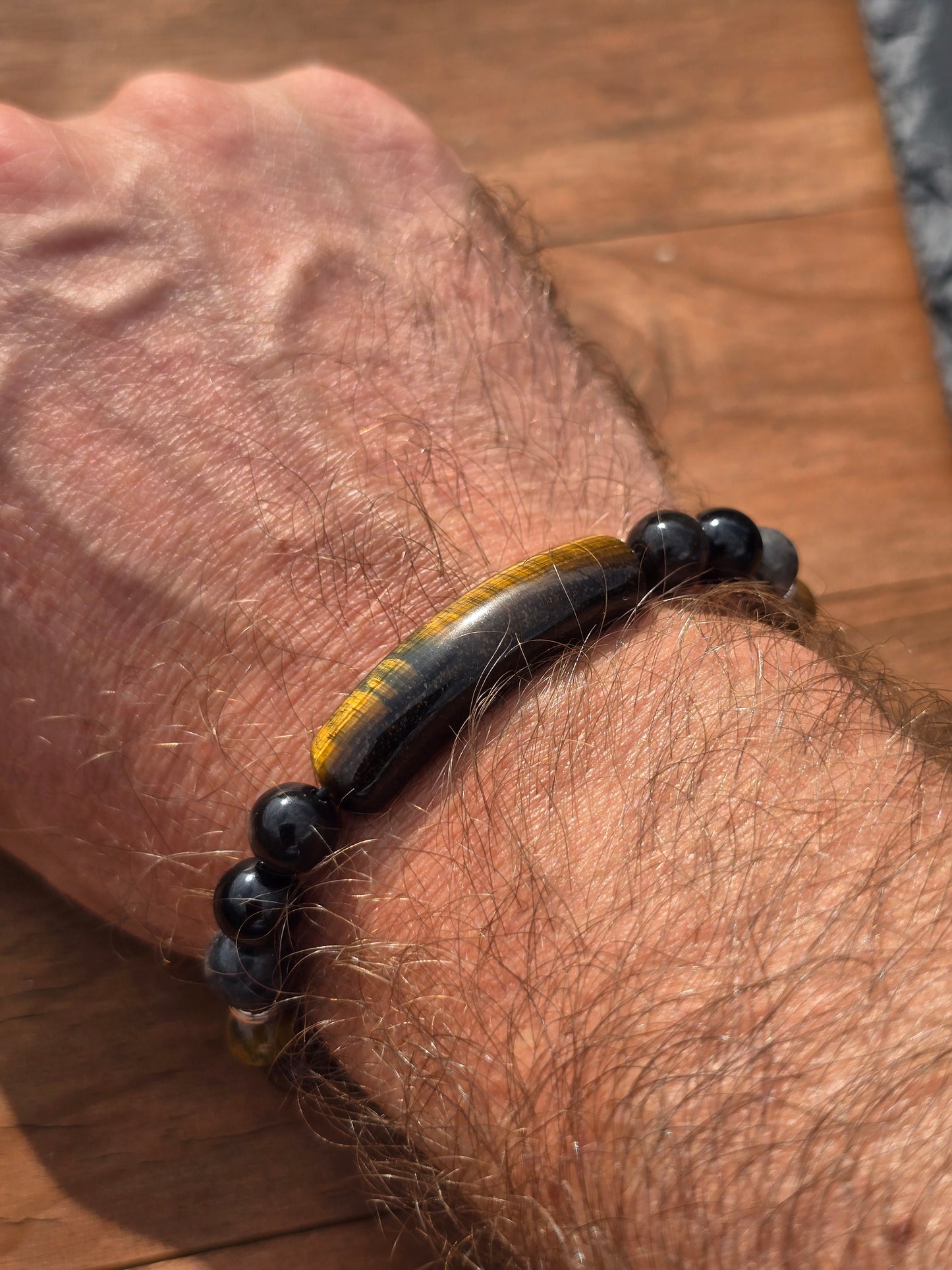 Men's tigers eye beaded bracelet with tigers eye bar bead top shot on wrist
