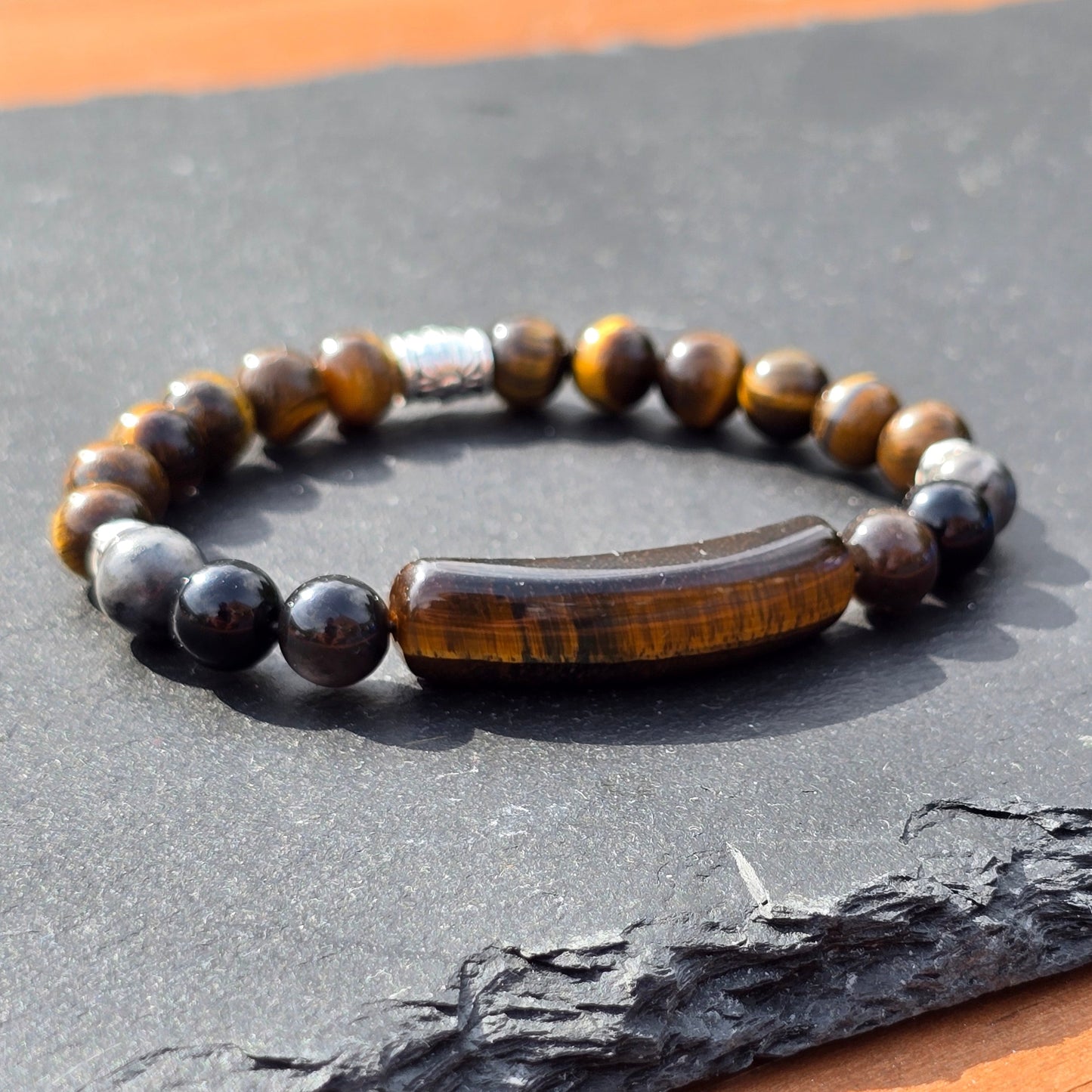Men's tigers eye beaded bracelet on a slate surface