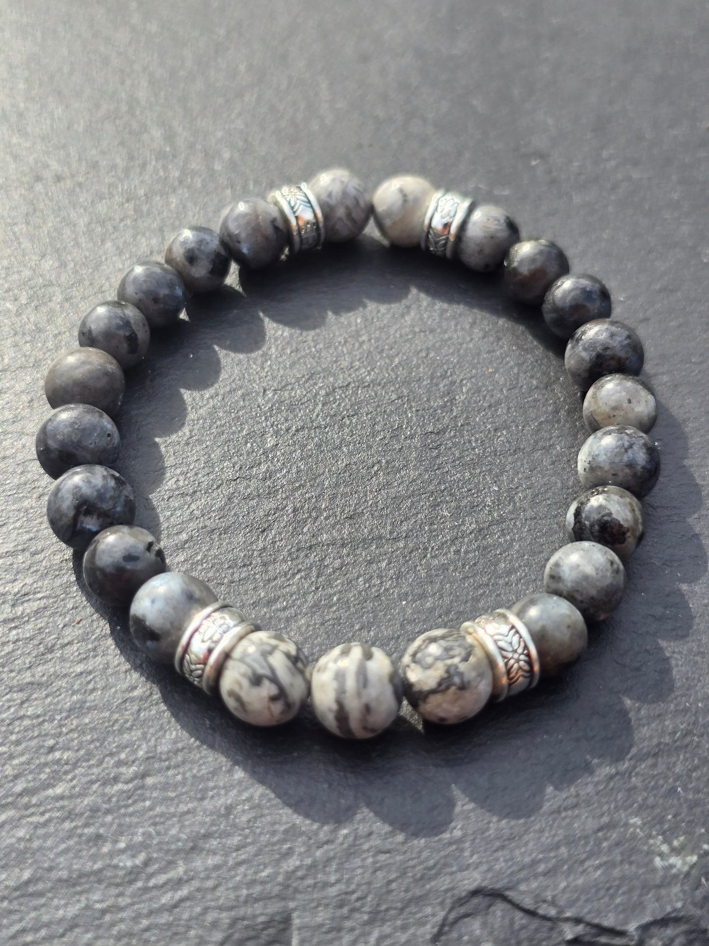 Beaded bracelet with stone-like beads on a slate surface