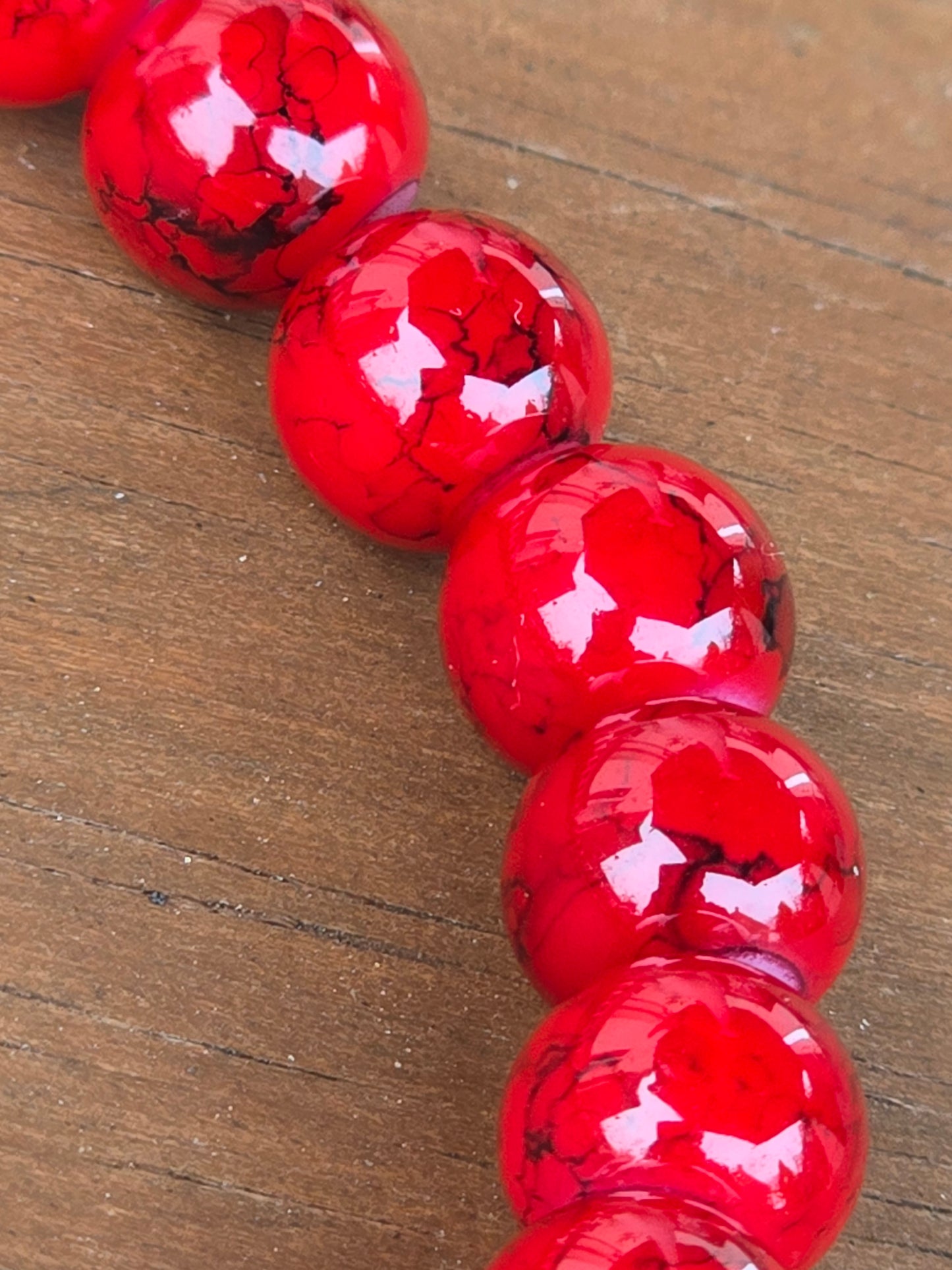 close up of the red beads on a red beaded womens bracelet