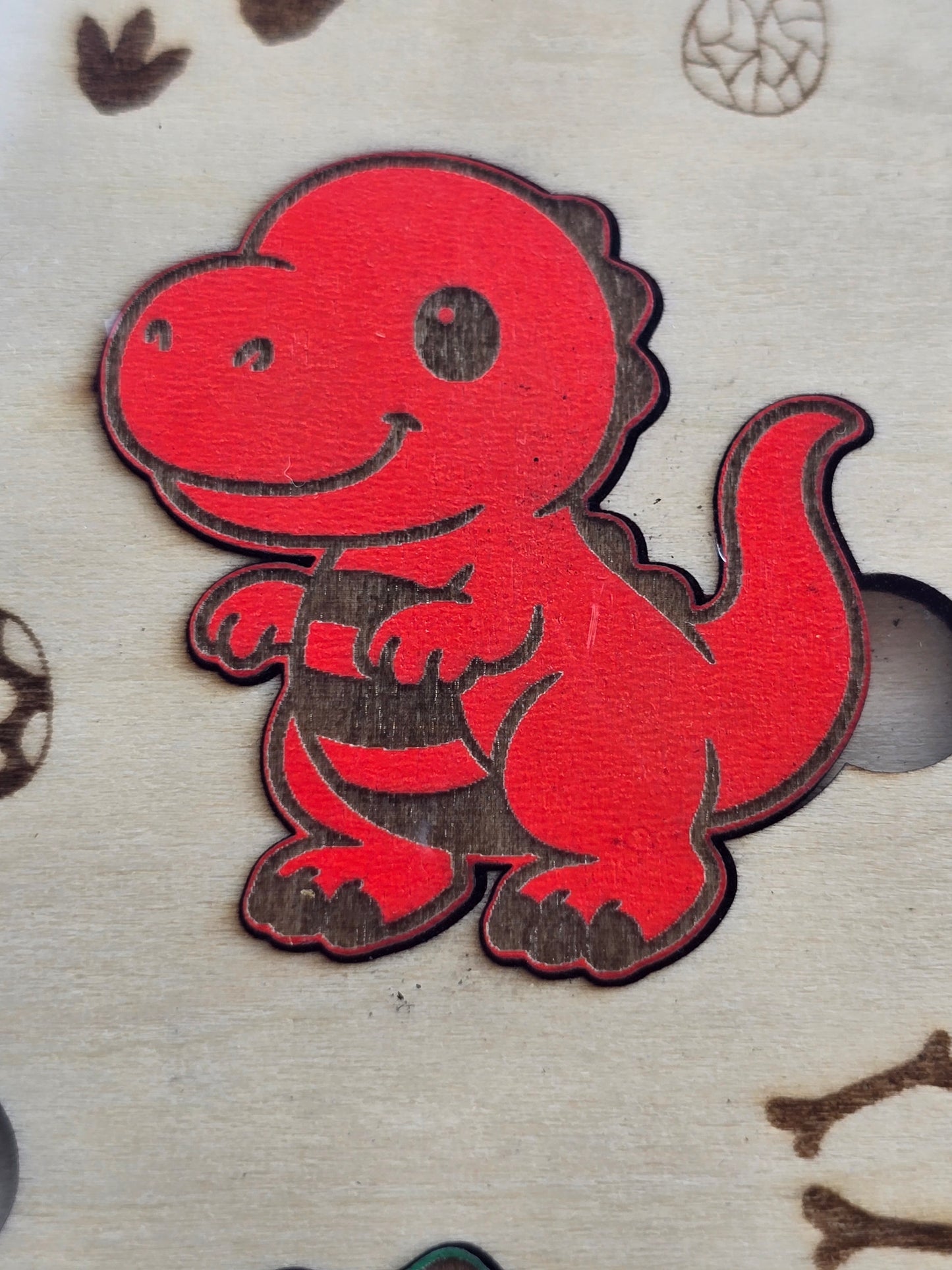 Red coloured dinosaur puzzle piece close up