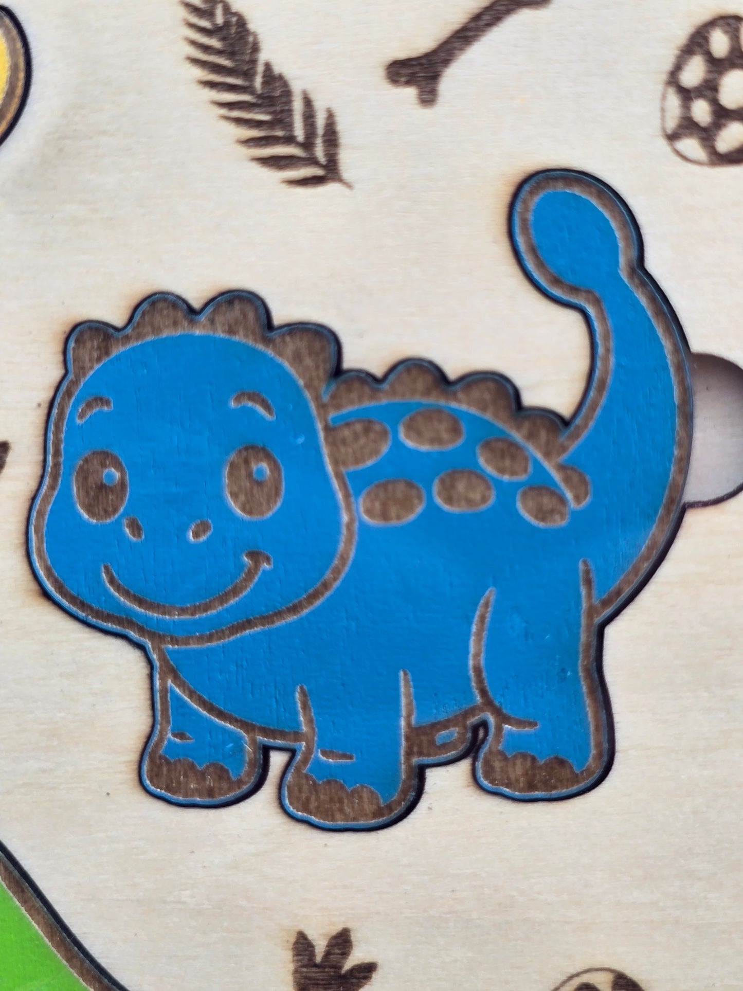 Blue wooden dinosaur puzzle piece, part of a kids dinosaur wooden puzzle game