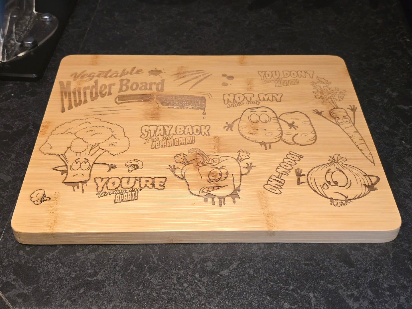 Wooden cutting board with humorous vegetable-themed designs on a dark surface