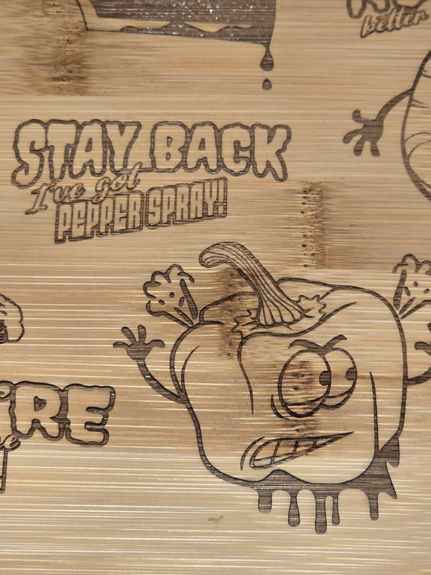 bamboo chopping board with etched pepper design and stay back I've got pepper spray text.