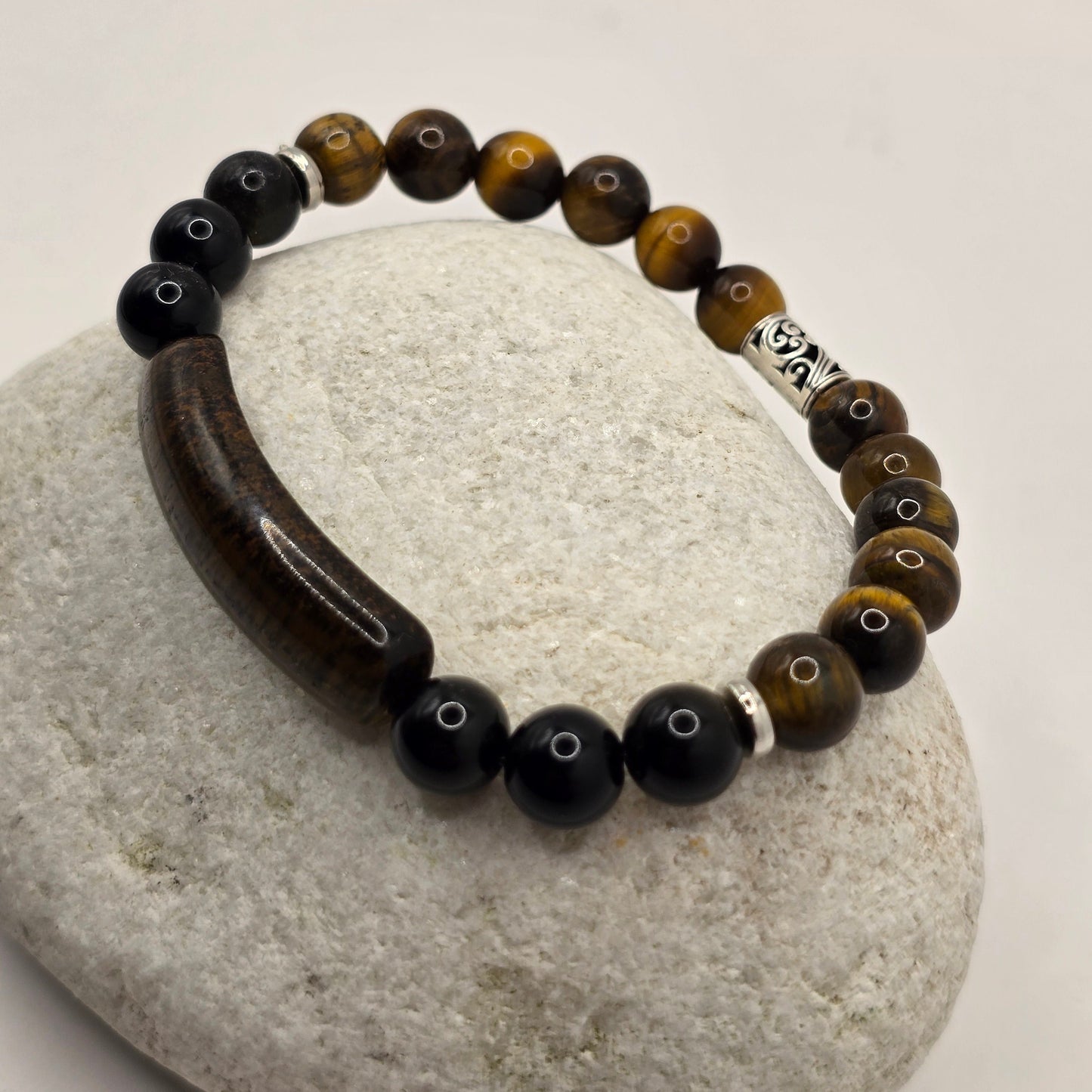Mens Tigers Eye Bar Bead Bracelet displayed on a stone