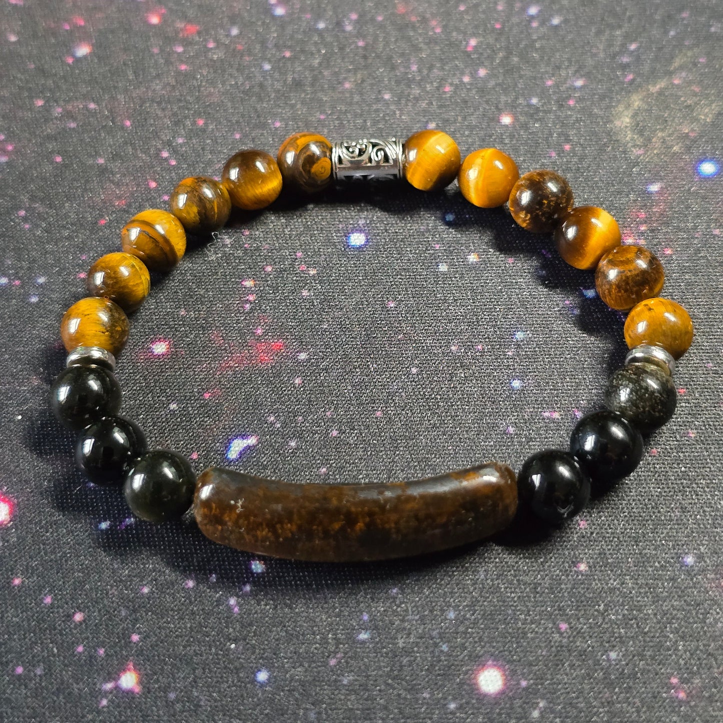 Beaded bracelet with yellow, black, and brown beads on a gray background