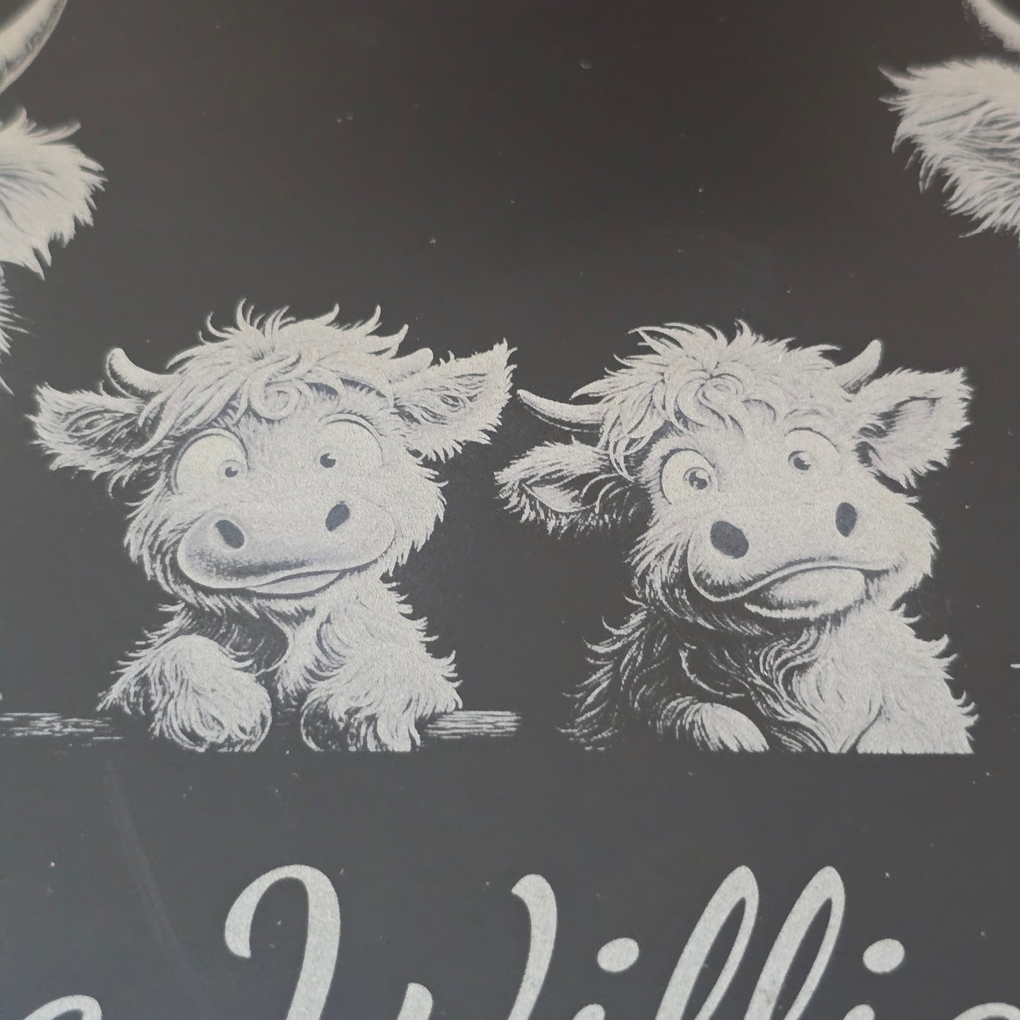 a highland cow family engraved on a personalised cheese slate