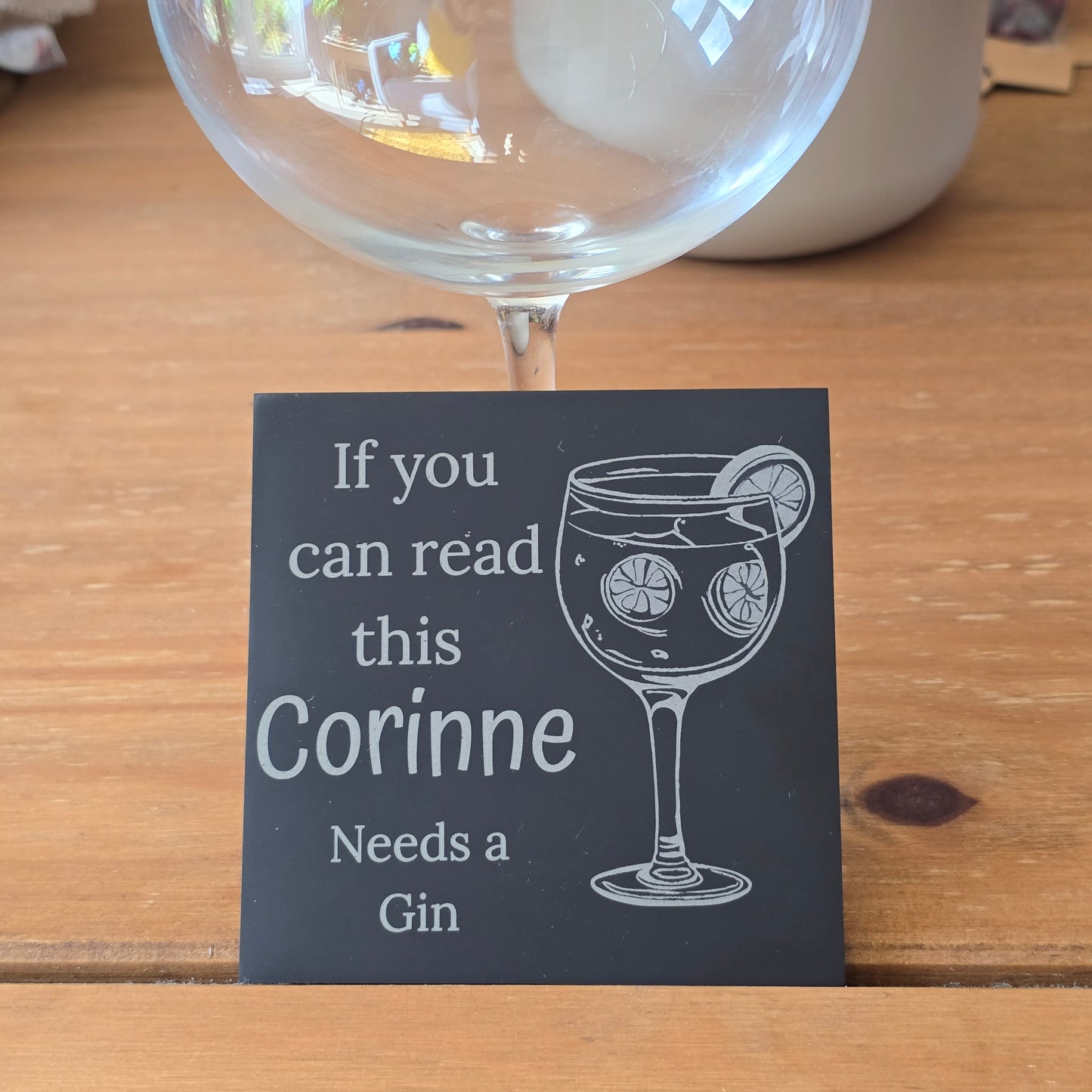 Glass of gin with a humorous personalised slate coaster
