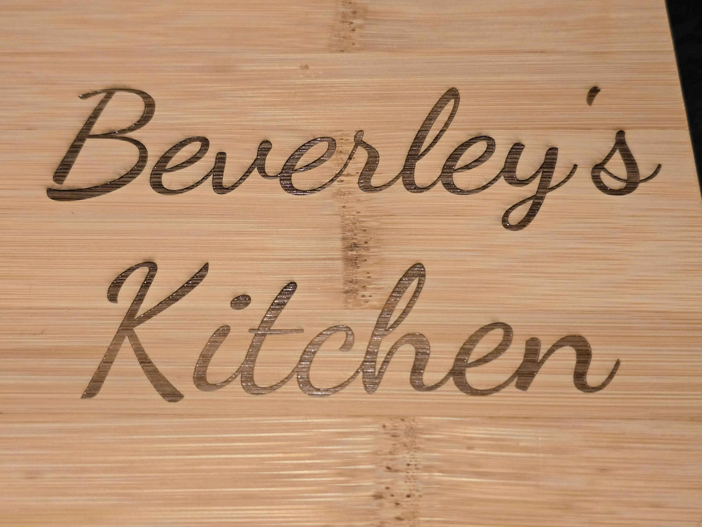 Wooden cutting board with 'Beverley's Kitchen' engraved on it