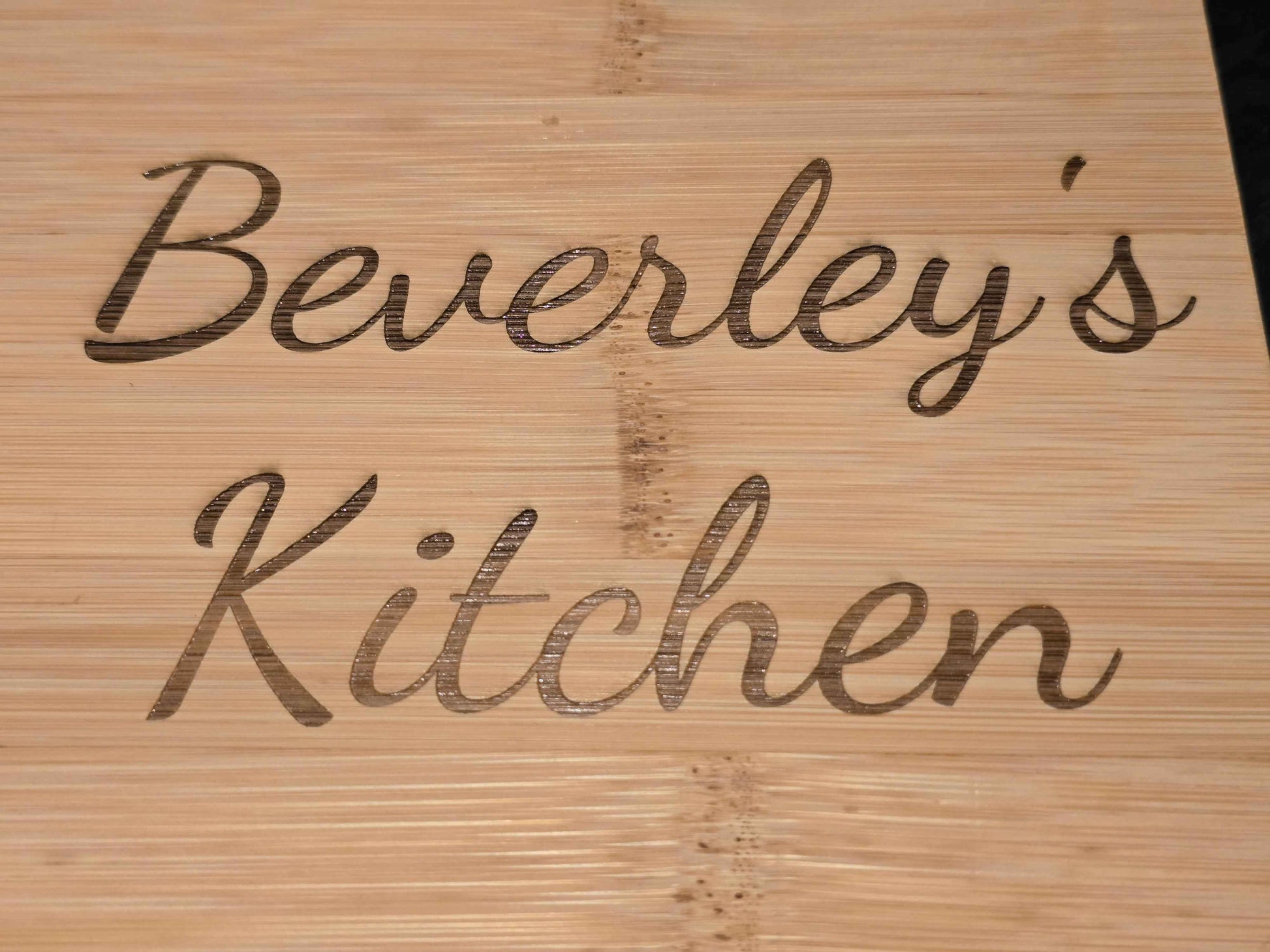 Wooden cutting board with 'Beverley's Kitchen' engraved on it