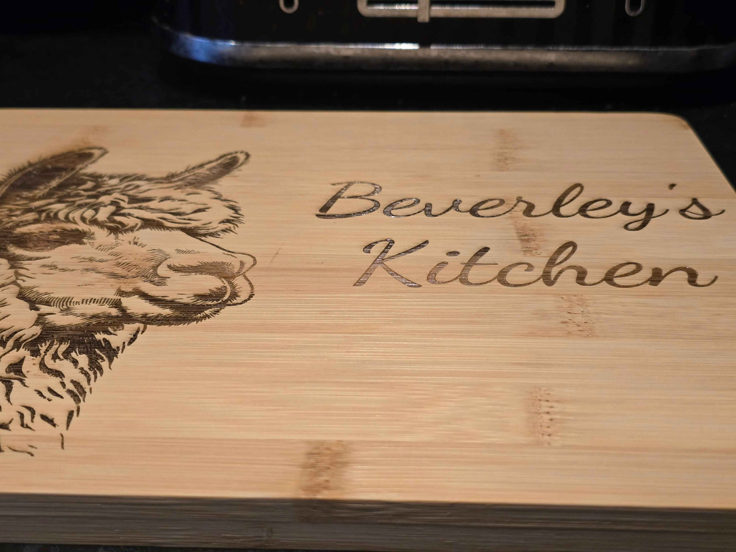 personalised Wooden cutting board with engraved alpaca illustration and 'Beverley's Kitchen' text.