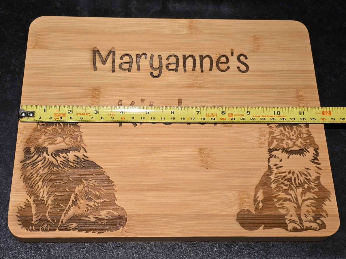 Wooden cutting board with engraved designs and 'Maryanne's' engraving, measured by a tape measure at 30cm length