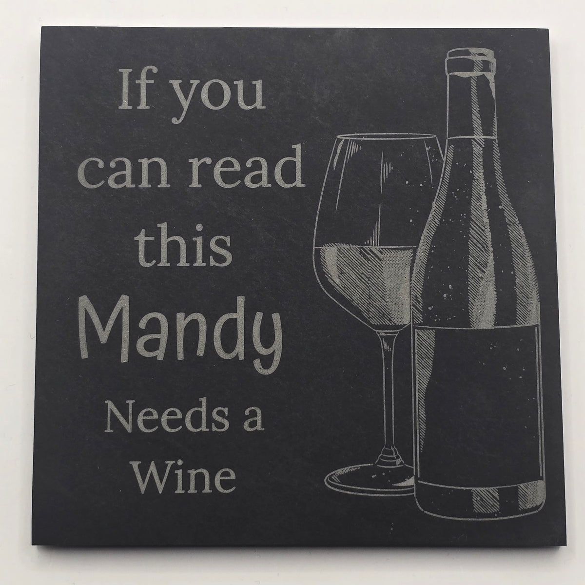 Black slate drinks mat with a wine bottle illustration and text 'If you can read this Mandy Needs a Wine' on a white background