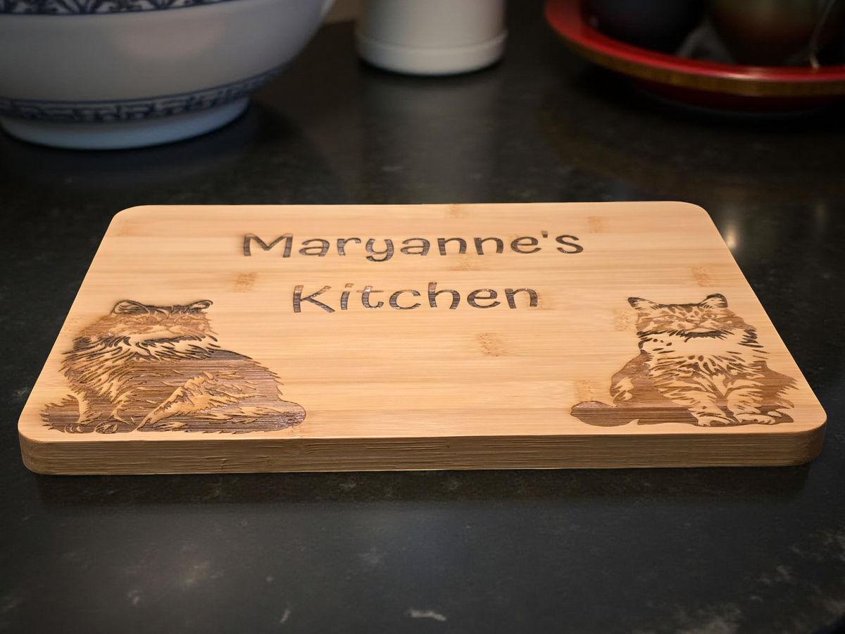 Wooden cutting board with 'Maryanne's Kitchen' engraving on a dark surface