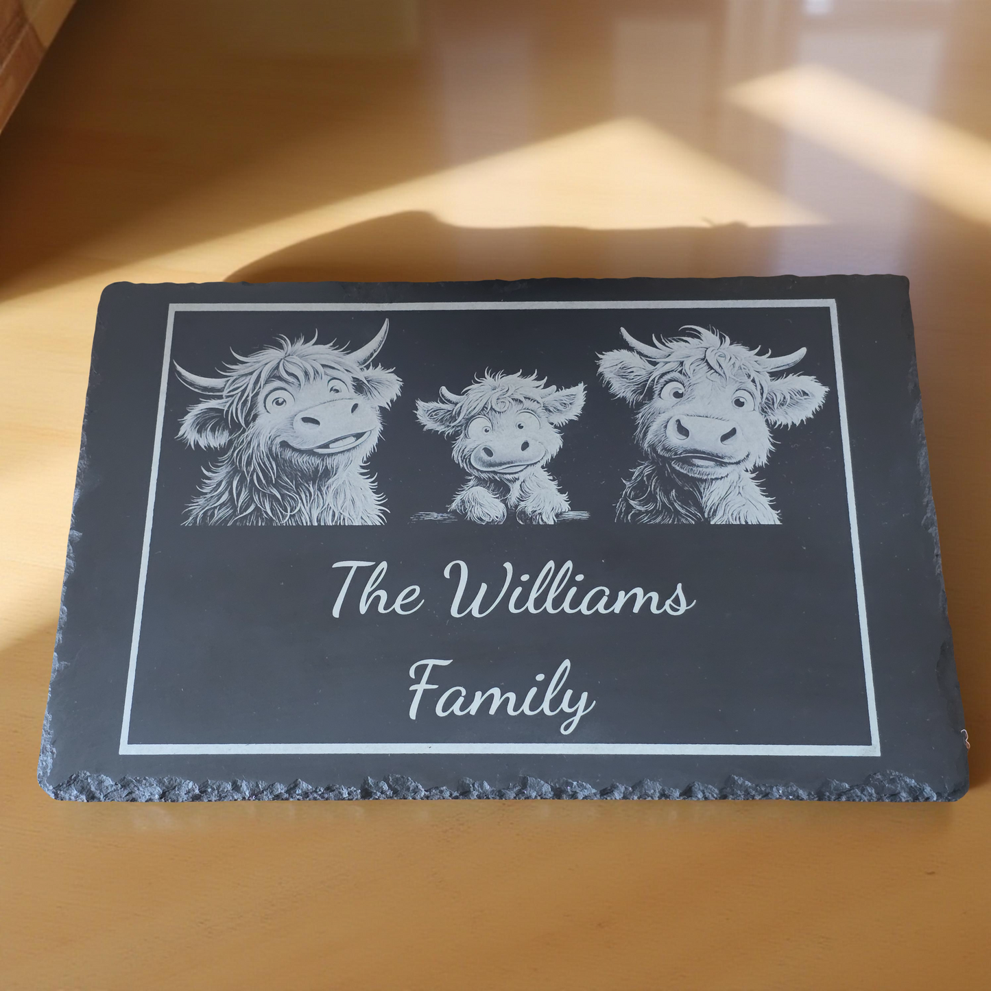 Personalised cheese Slate with engraved Highland cow illustrations and 'The Williams Family' text