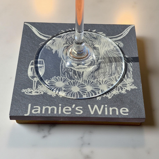 Wine glass on a coaster with 'Jamie's Wine' branding