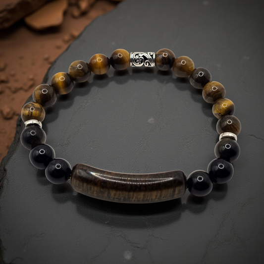 Beaded bracelet with tiger eye and black stones on a dark surface