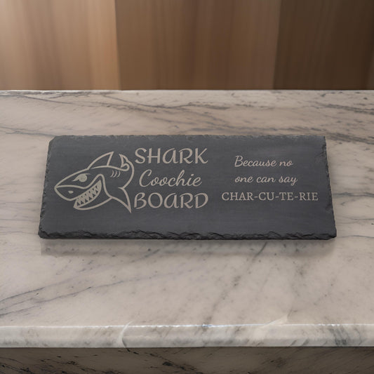 Slate charcuterie board with shark image and shark coochie coard text
