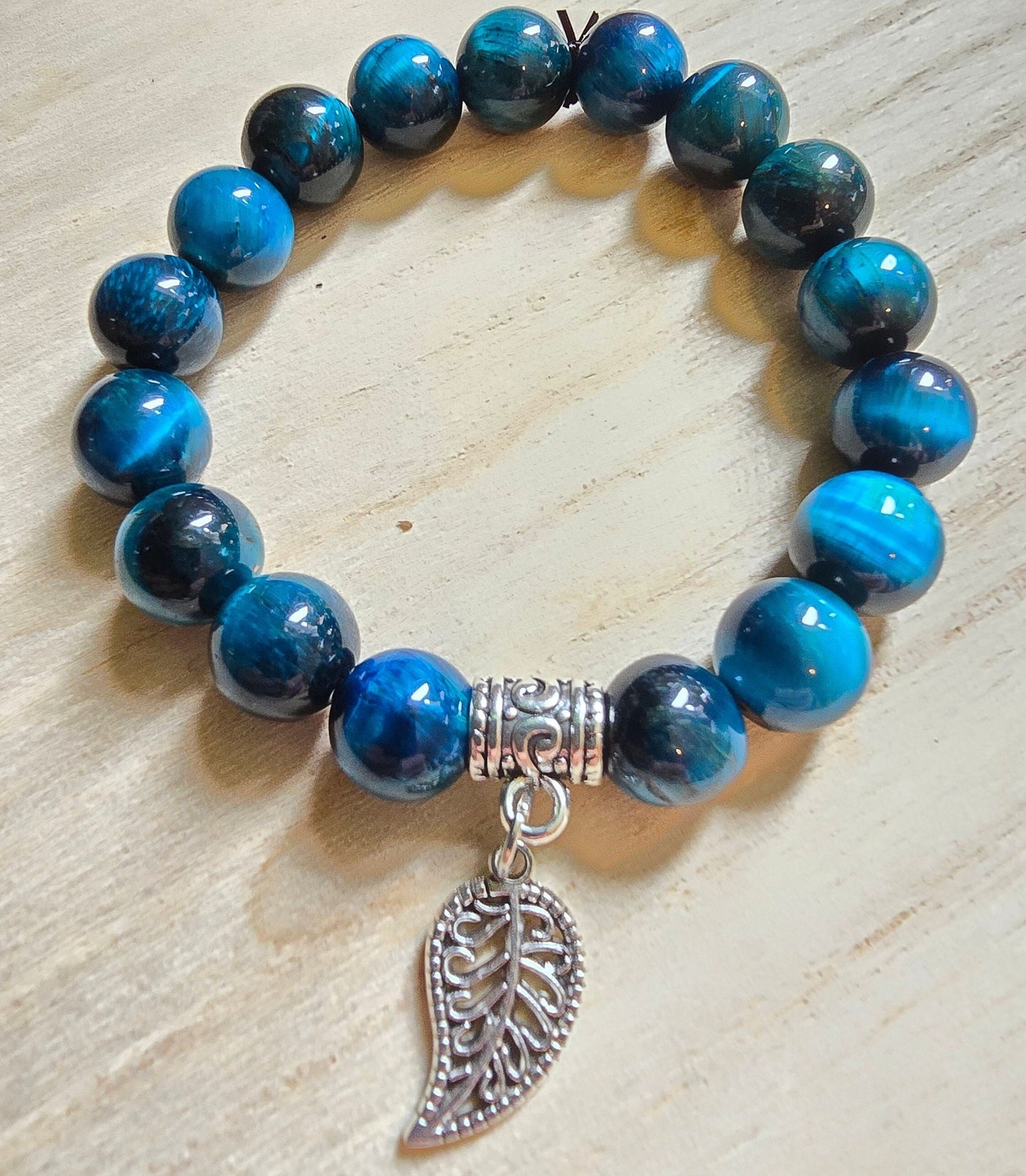 Blue Glass Beaded elasticated bracelet with silver leaf dangle charm