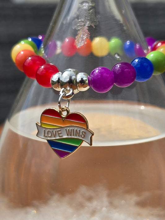 rainbow coloured elasticated beaded bracelet with pride theme charm