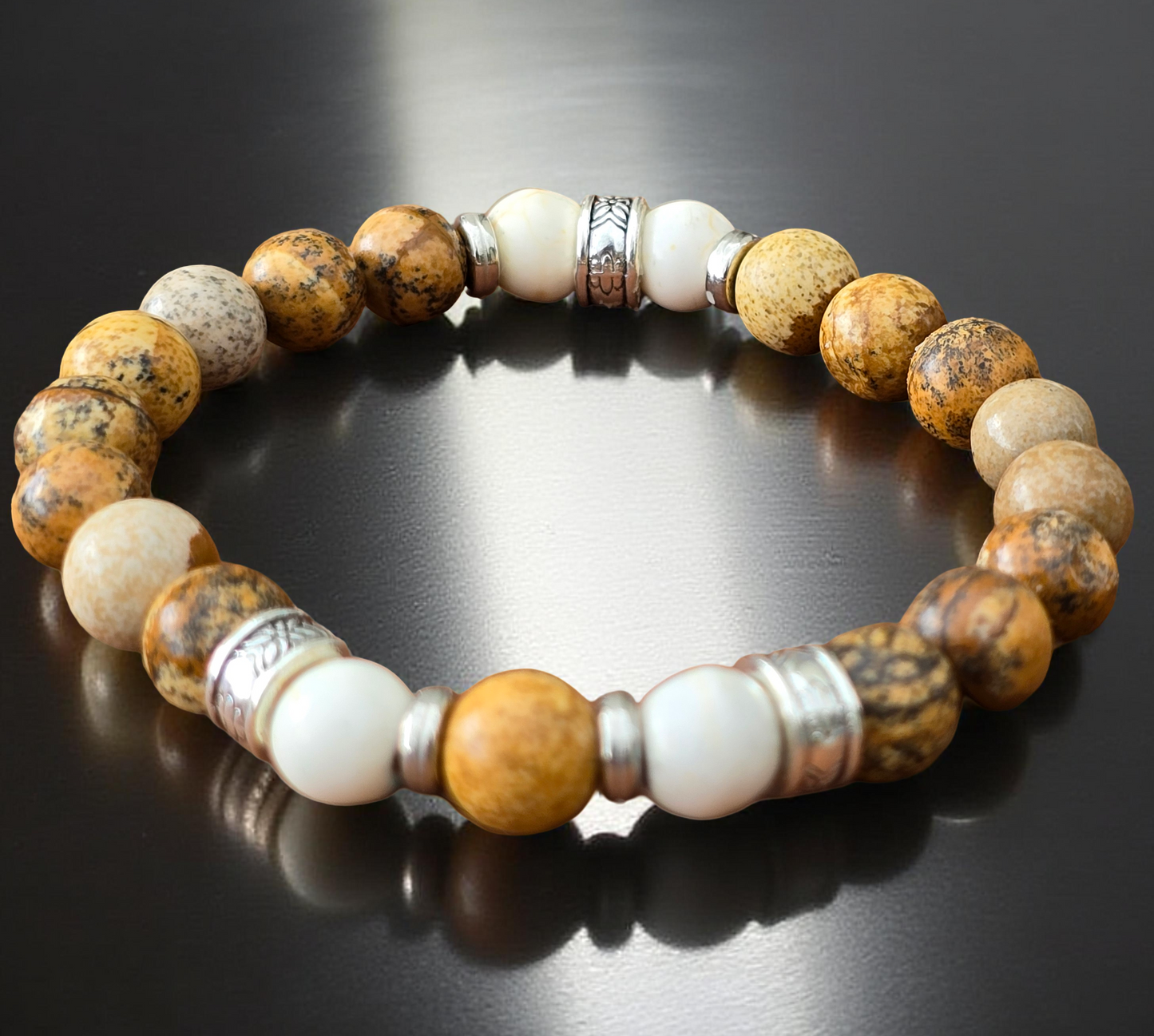Wooden effect beaded bracelet with brown, white, and silver beads on a reflective black surface