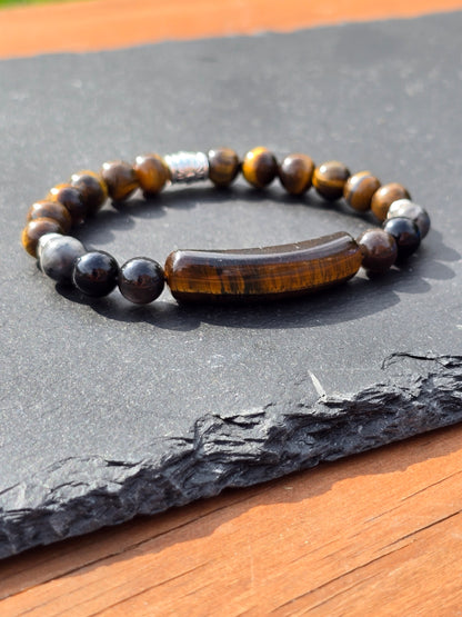 Men's tigers eye beaded bracelet on a slate surface