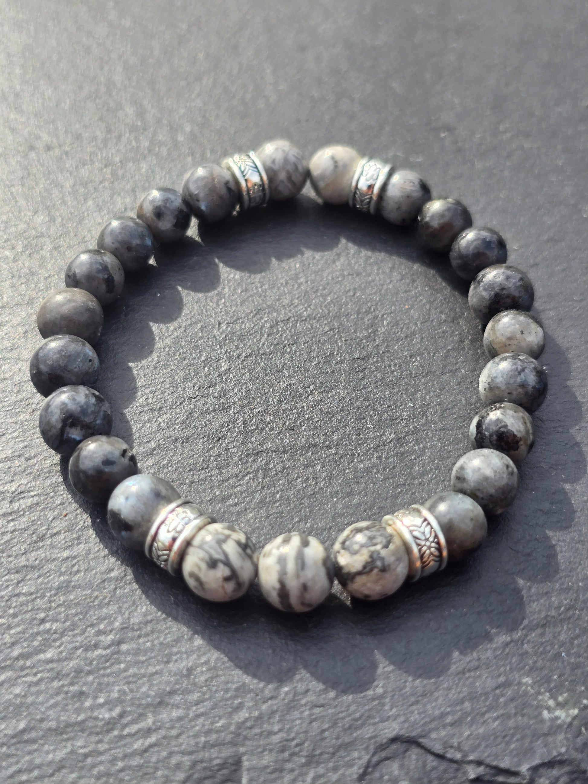 Beaded bracelet with stone-like beads on a slate surface