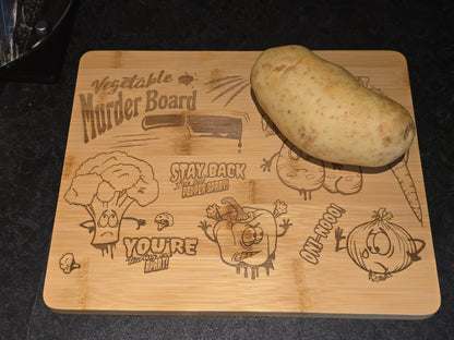 Wooden cutting board with humorous vegetable-themed designs and a potato on top.