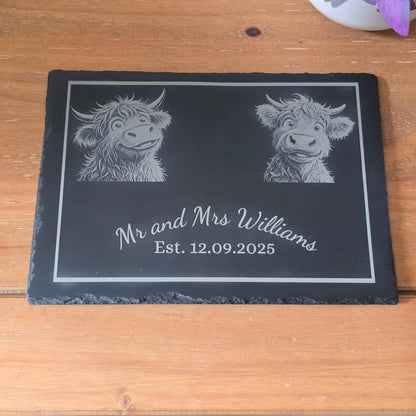 Personalised slate plaque with engraved Highland cow designs and text on a wooden surface