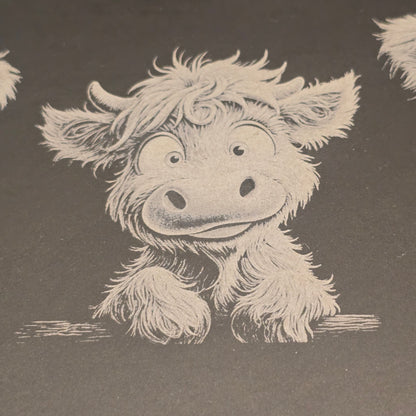 Cute baby highland cow engraving on a slate surface