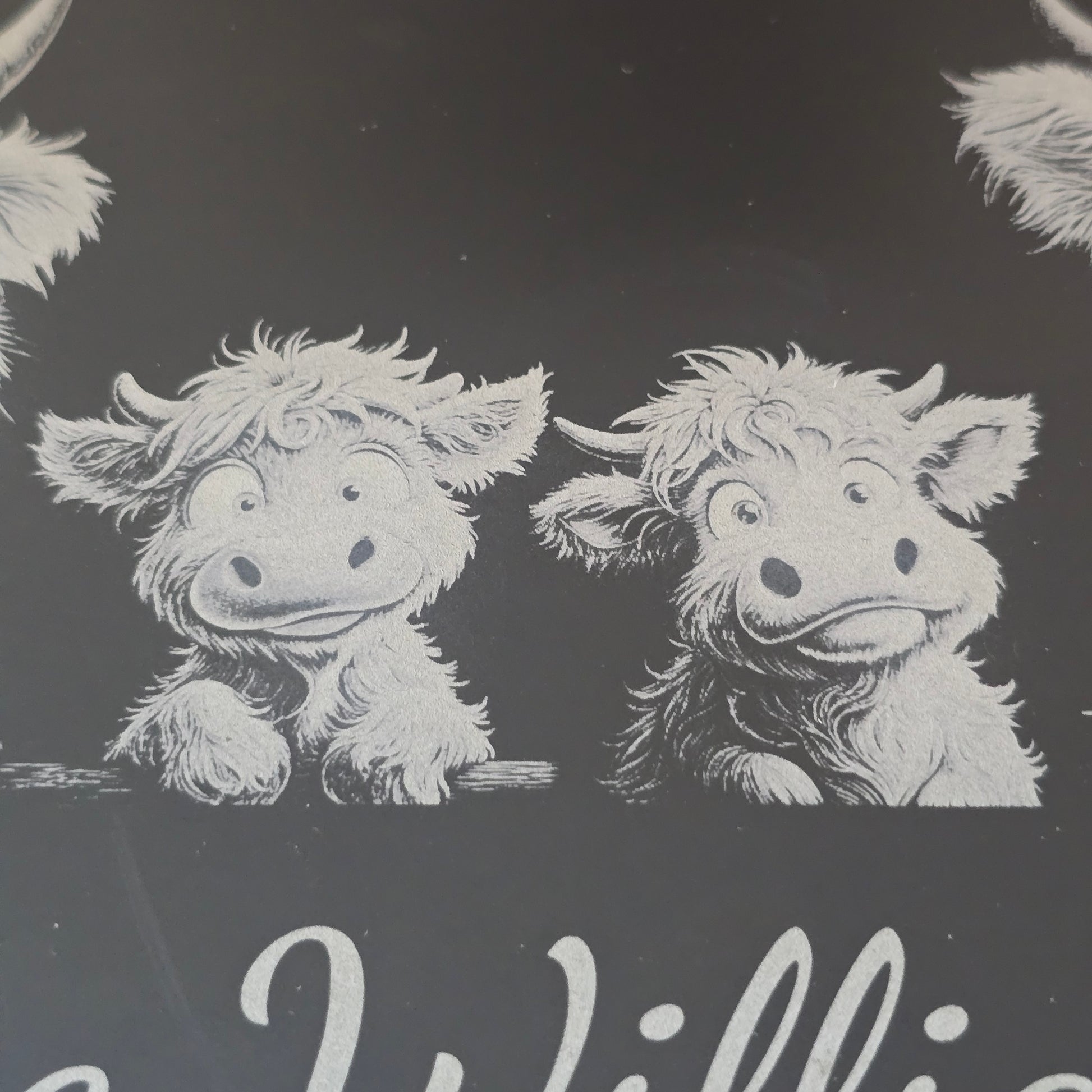 a highland cow family engraved on a personalised cheese slate