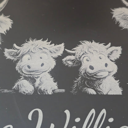 a highland cow family engraved on a personalised cheese slate
