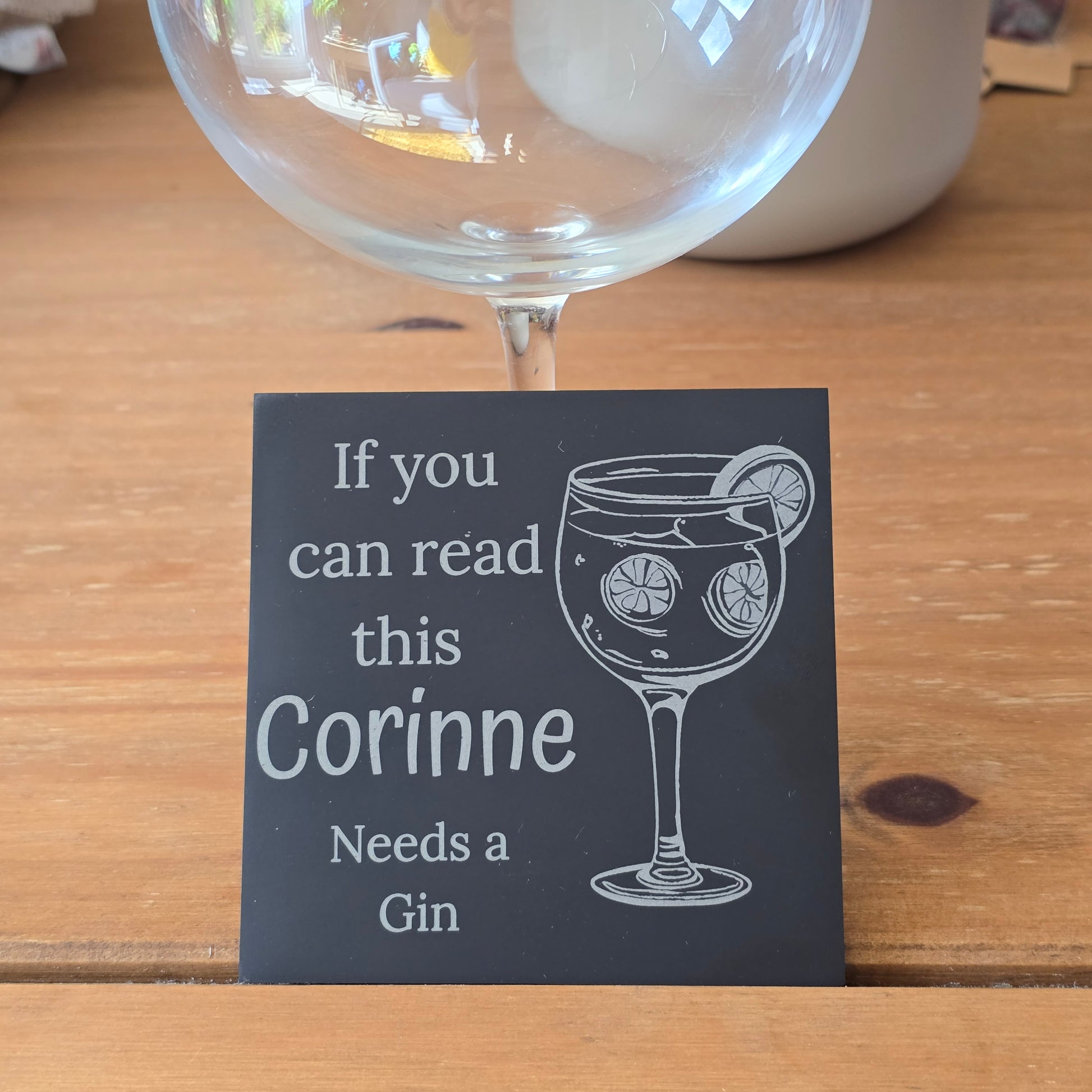 Glass of gin with a humorous personalised slate coaster