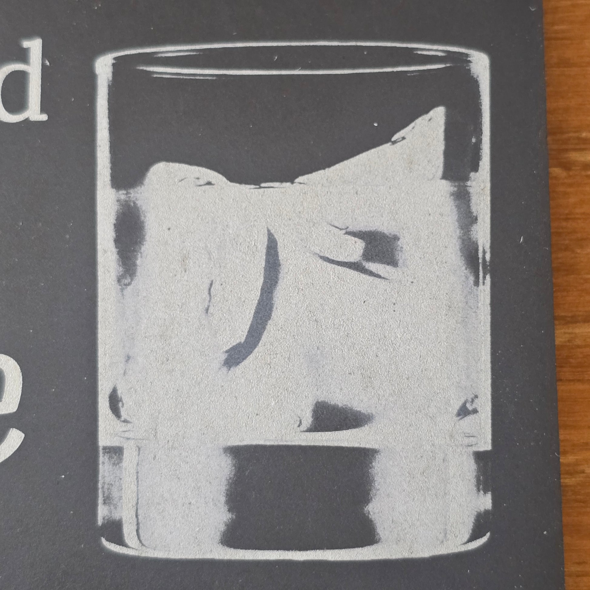 engraving of a whiskey glass on a slate coaster