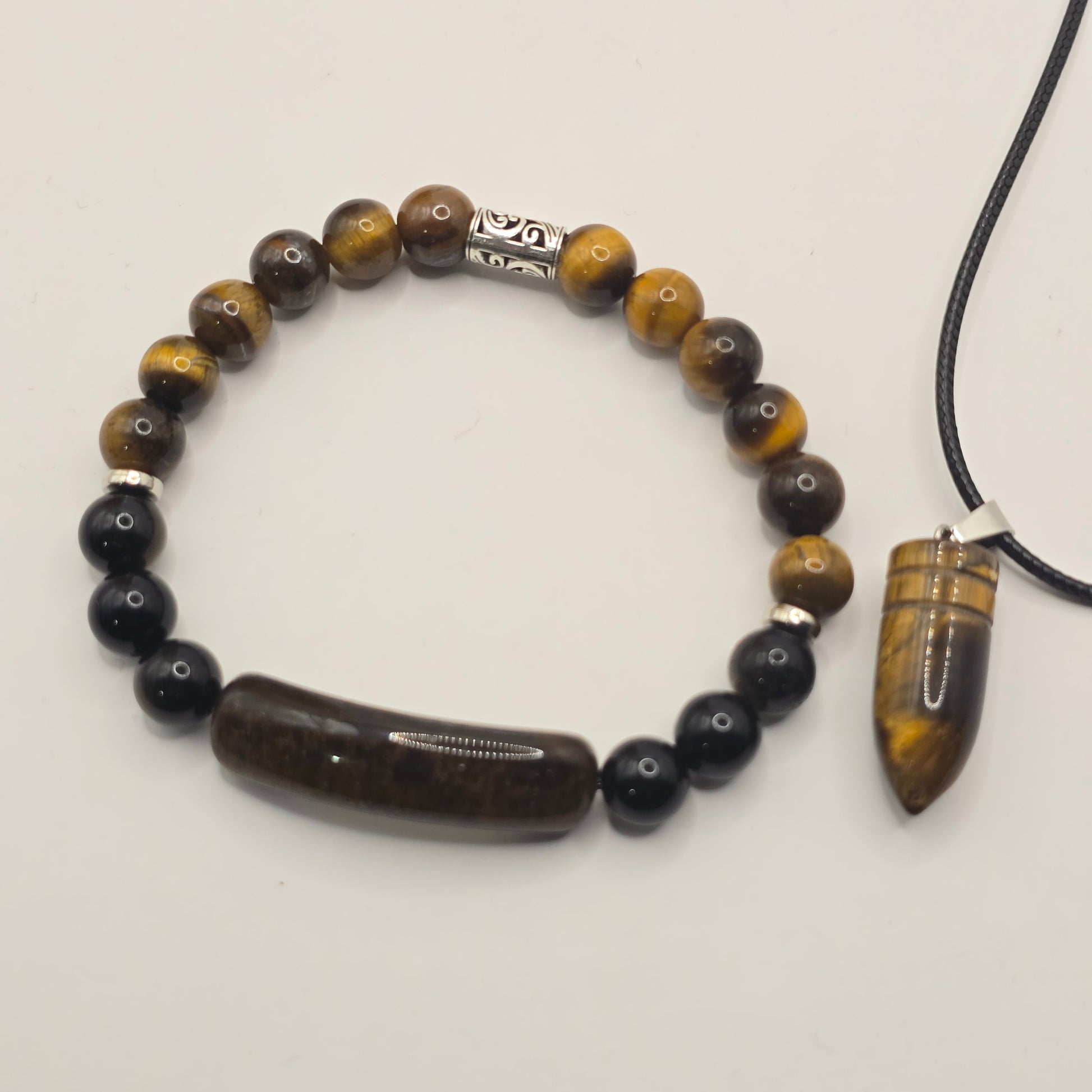 Beaded bracelet with tiger eye and black stones on a white background