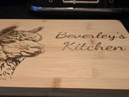personalised Wooden cutting board with engraved alpaca illustration and 'Beverley's Kitchen' text.