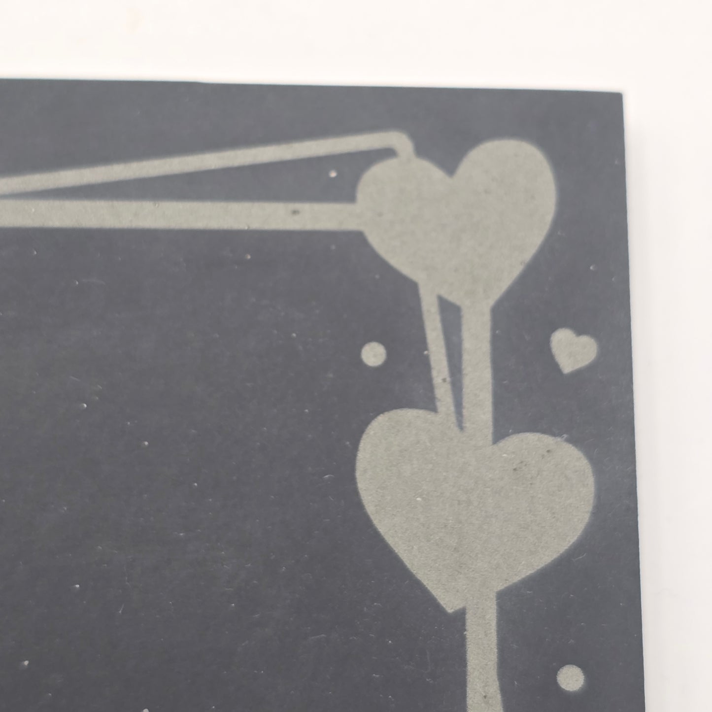 Abstract heart design with two heart shapes on a dark slate