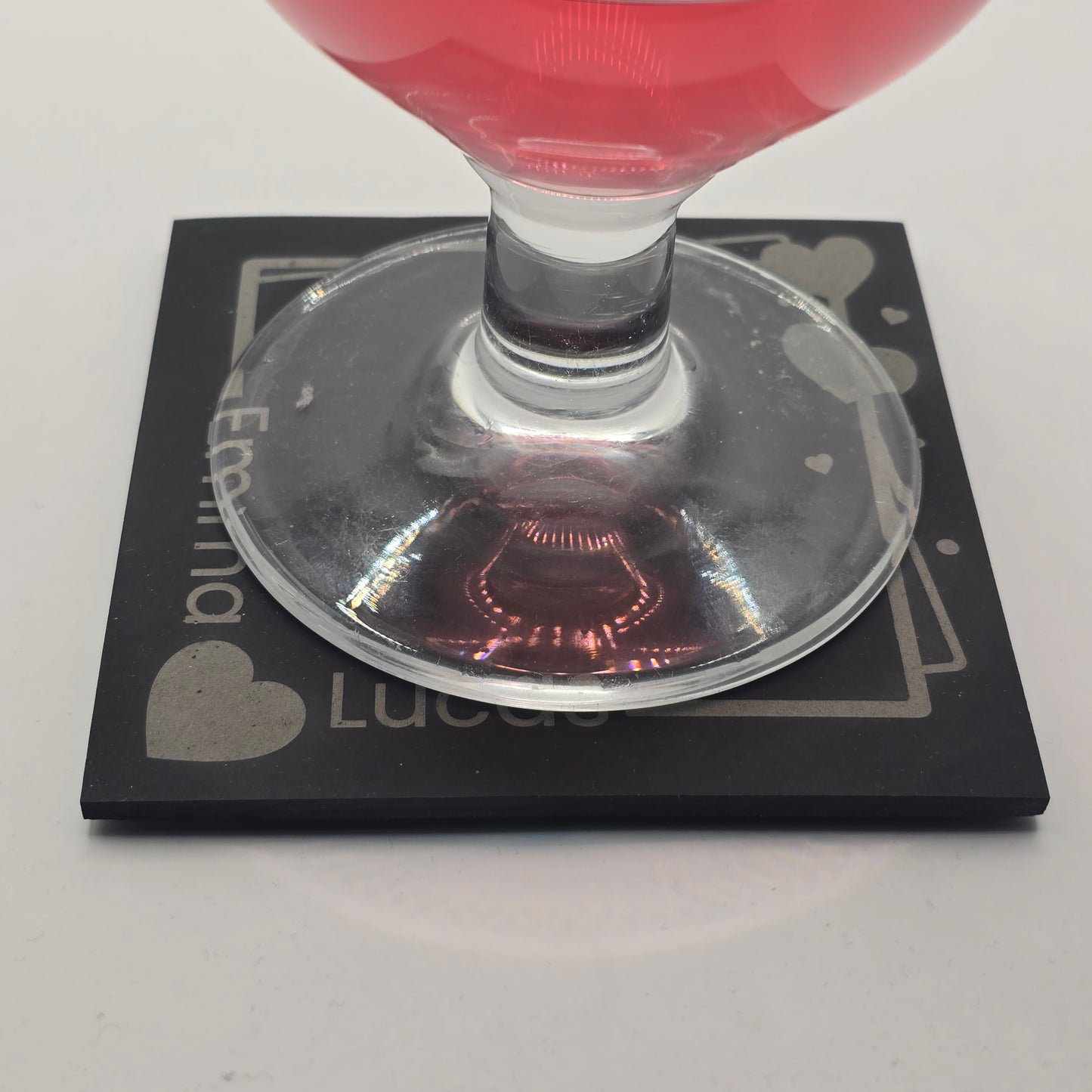 custom slate with his and her names with a glass sitting on it