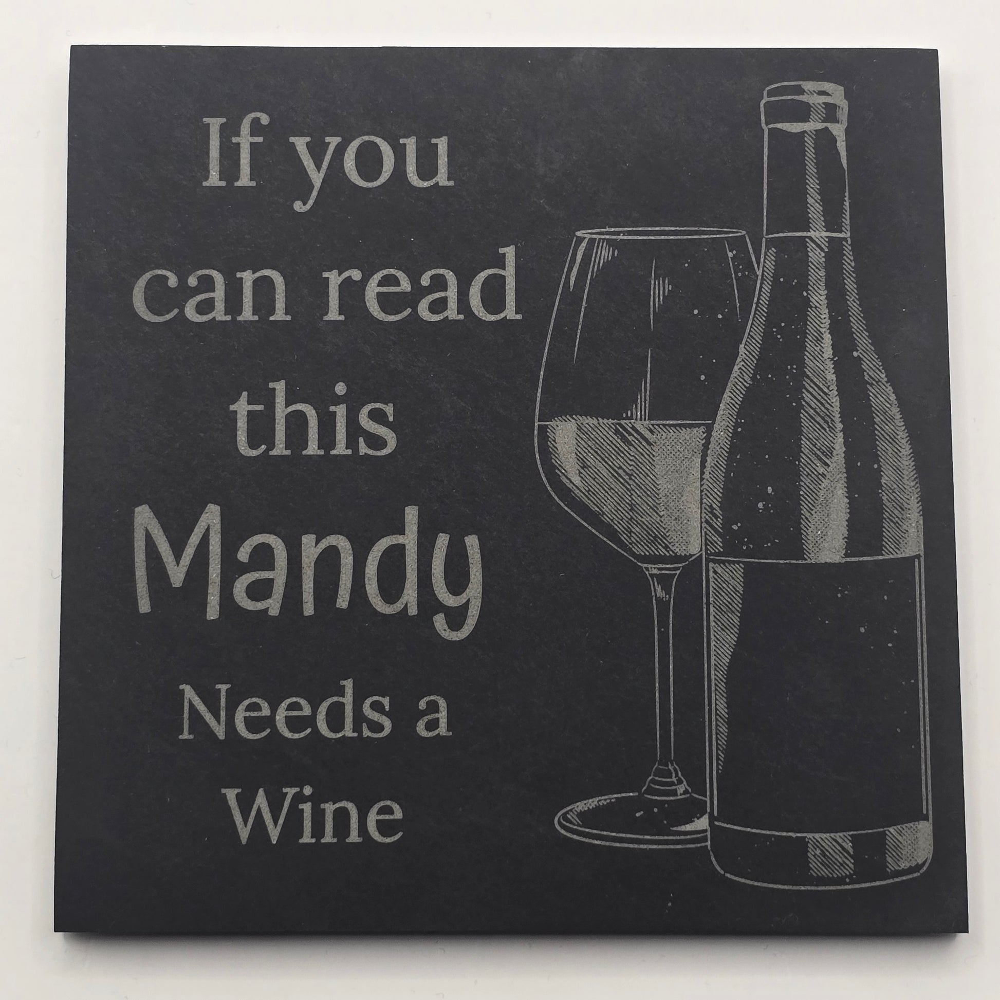 Black slate drinks mat with a wine bottle illustration and text 'If you can read this Mandy Needs a Wine' on a white background