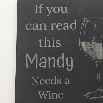 Black slate with white text and wine graphics, featuring the phrase 'If you can read this Mandy Needs a Wine'.