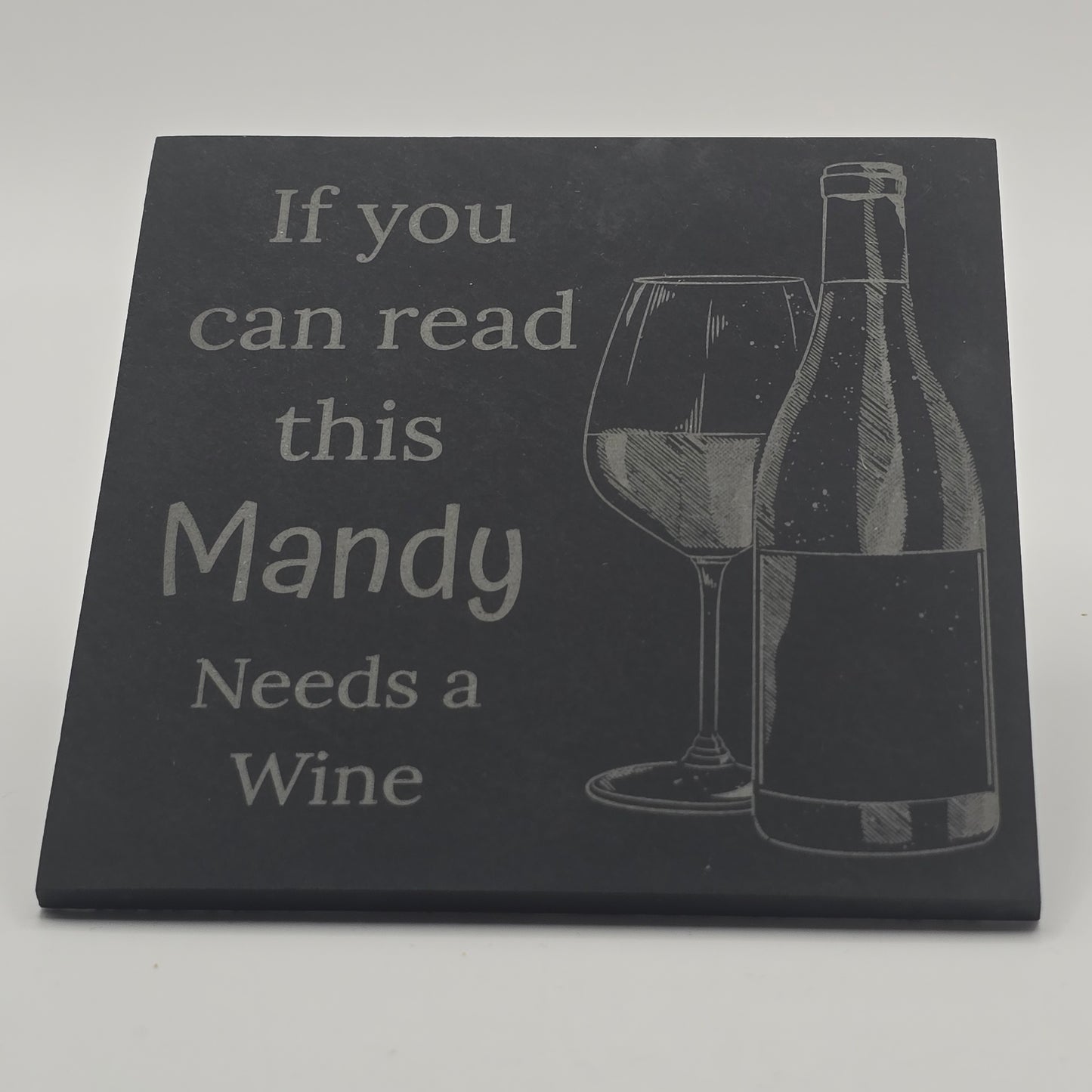 smooth black slate coaster with a wine bottle and glass engraving and funny wine quote