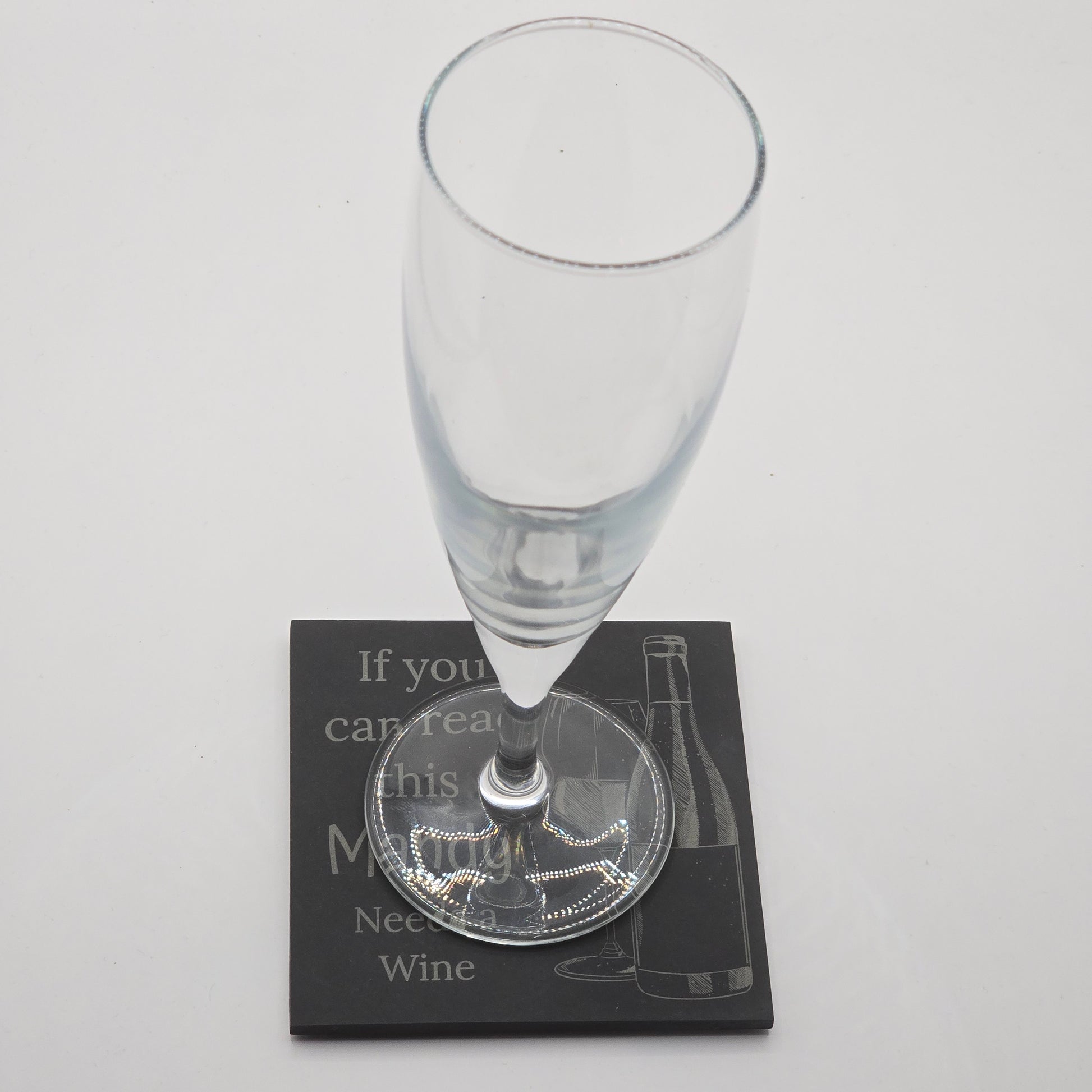 champaign flute resting on a custom coaster with the text "if you can read this Mandy needs a wine"
