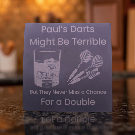 personalised slate coaster with the slogan "Pauls darts might be terrible, but they never miss a chance for a double"