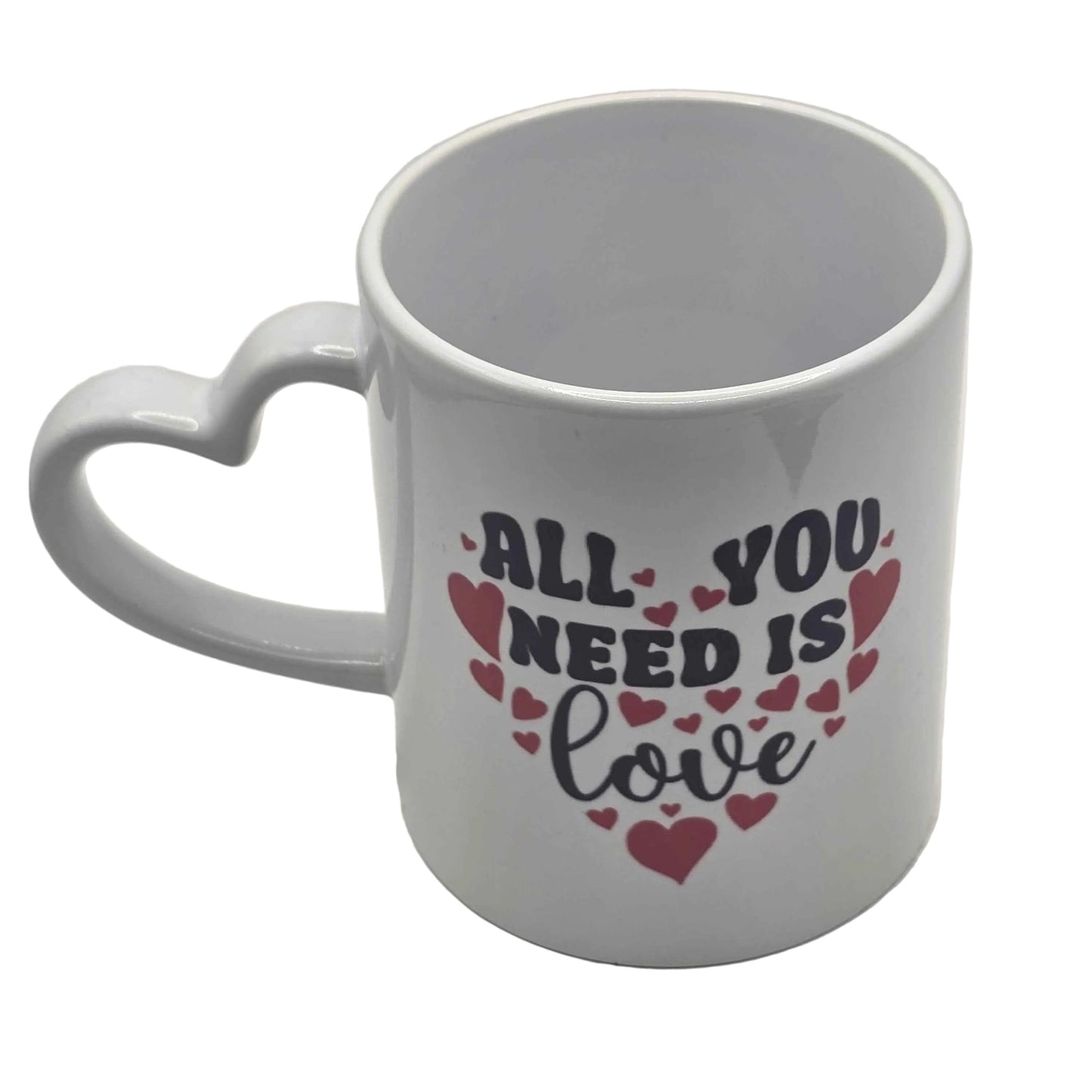 White mug with heart handle and 'All you need is love' text on a white background