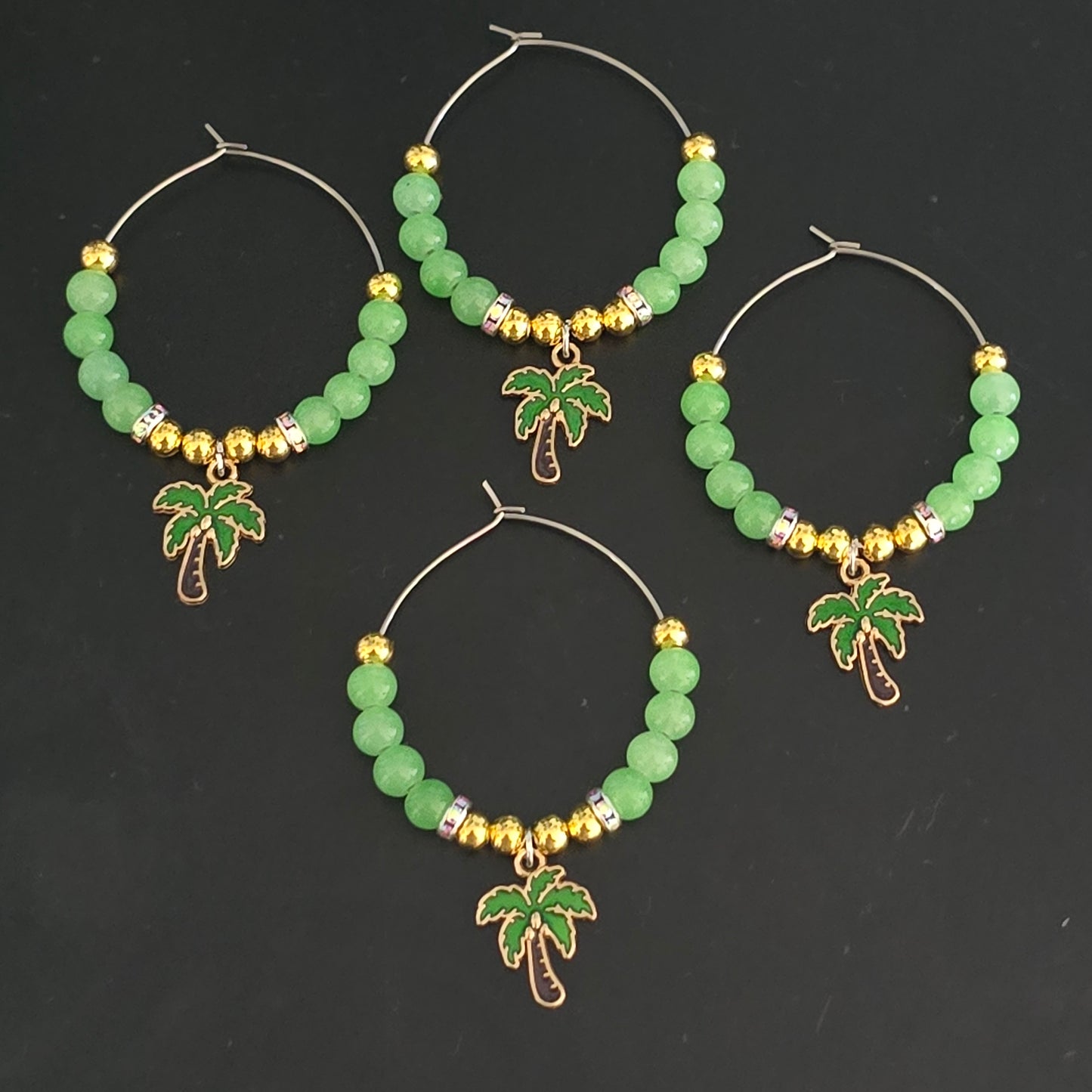 Set of 4 green and gold beaded wine glass decorations with palm tree charms
